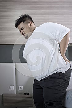 Obese man having backache after waking up