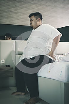 Obese man having backache after waking up