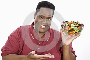 An Obese Man Holding Bowl Of Salad