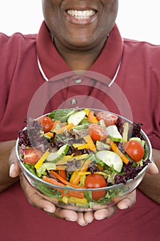 An Obese Man Holding Bowl Of Salad