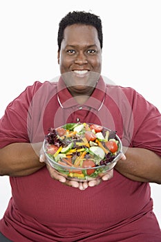 An Obese Man Holding Bowl Of Vegetable Salad