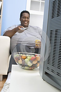 Obese Man Holding Glass Of Juice