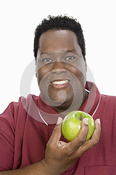 An Obese Man Holding Green Apple