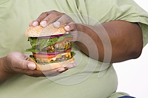 An Obese Man Holding Hamburger