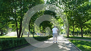 Obese man jogging in park, struggling with overweight, daily hard workouts