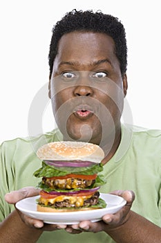 An Obese Man Looking At Hamburger