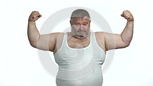 Obese man showing biceps on white background.