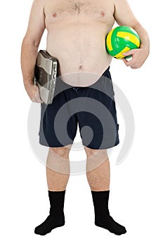 Obese man stands with scales and ball