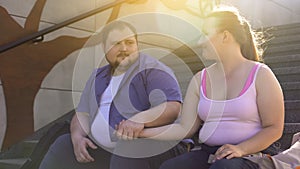 Obese man tenderly holding his fat girlfriend hand, true feelings, dating
