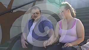 Obese man tenderly holding his girlfriend hand, true feelings, first meeting