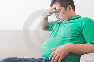 Obese man thinking about his weight problem