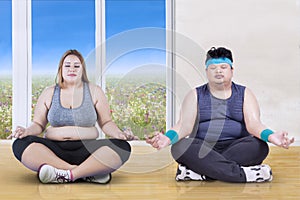 Obese people doing yoga poses