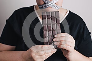 Obese woman with chocolate, eating disorder