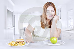 Obese woman chooses healthy food