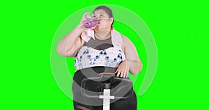 Obese woman doing cardio workout while drinking