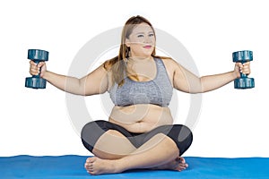 Obese woman doing exercise with dumbbells on mat