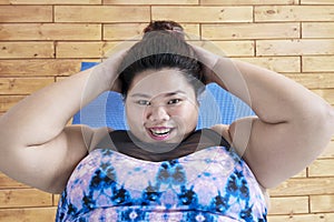 Obese woman doing sit ups