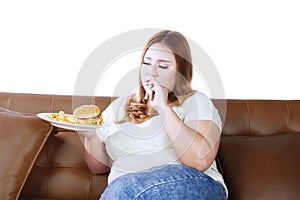 Obese woman eating a junk food