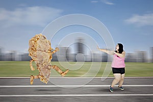 Obese woman escaping from a fried chicken