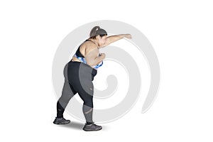 Obese woman exercising with punching style