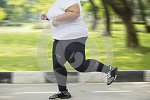 Obese woman feet sprinting on the road