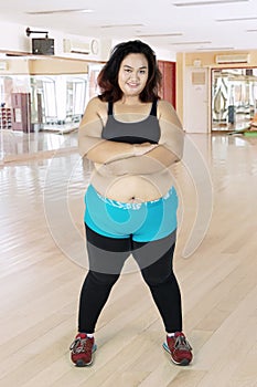 Obese woman folded her arms in the fitness center