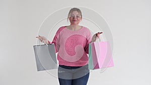 Obese woman holding shopping bags and dancing