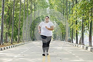 Obese woman jogging on the road