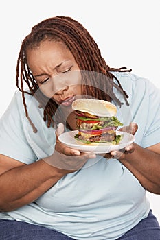 Obese Woman Looking At Burger