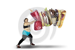 Obese woman punching unhealthy food