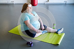 Obese Woman Resting after Workout