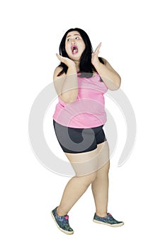 Obese woman with scared expression on studio