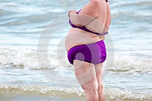 Obese woman at the sea.