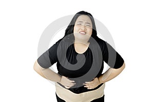 Obese woman suffering from abdominal pain