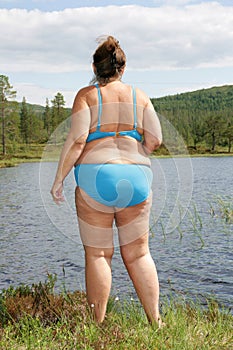 Obese woman by a tarn