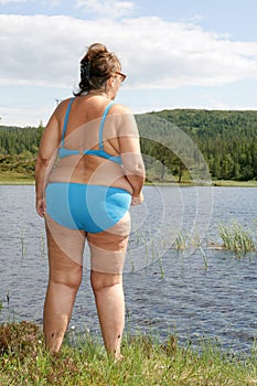 Obese woman by a tarn