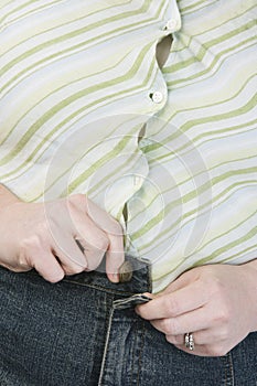 Obese Woman Trying To Button A Jeans