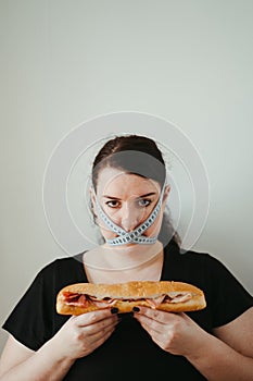Obese woman with unhealthy food, eating disorder