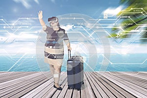 Obese woman wears VR glasses at pier