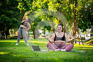 An obese woman who turns to exercise to take care of her health and lose weight on lawn in a fun way