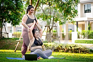 An obese woman who turns to exercise to take care of her health and lose weight on lawn in a fun way