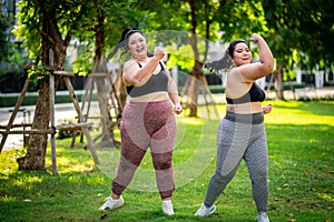 An obese woman who turns to exercise to take care of her health and lose weight on lawn in a fun way