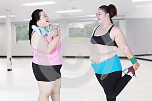 Obese women doing stretching together
