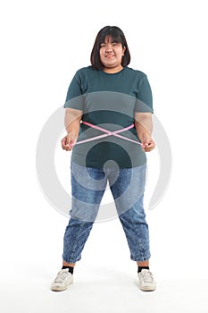 Obese women trying to lose weight use a tape measure around their waist to check their size.