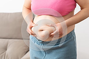 obese young woman checking her fats