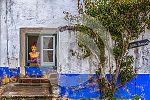 View of street shop with a weird mannequin on window