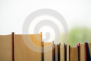 Object education green nature background with stack of ancient books or old bible, open paper book on wooden table with copy space