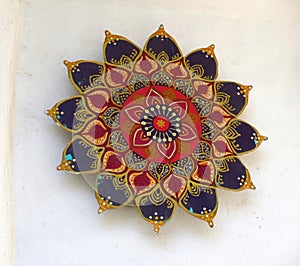 Object hanging on whitewashed wall