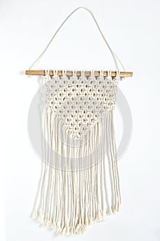 Object, macrame cotton on white background. Decorative handmade hobby interior for hanging on wall . DIY and hobby concept