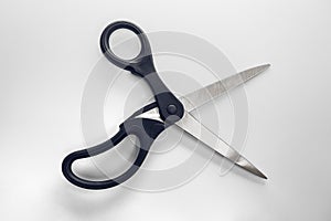 Object metal stainless steel and black plastic scissors opened o